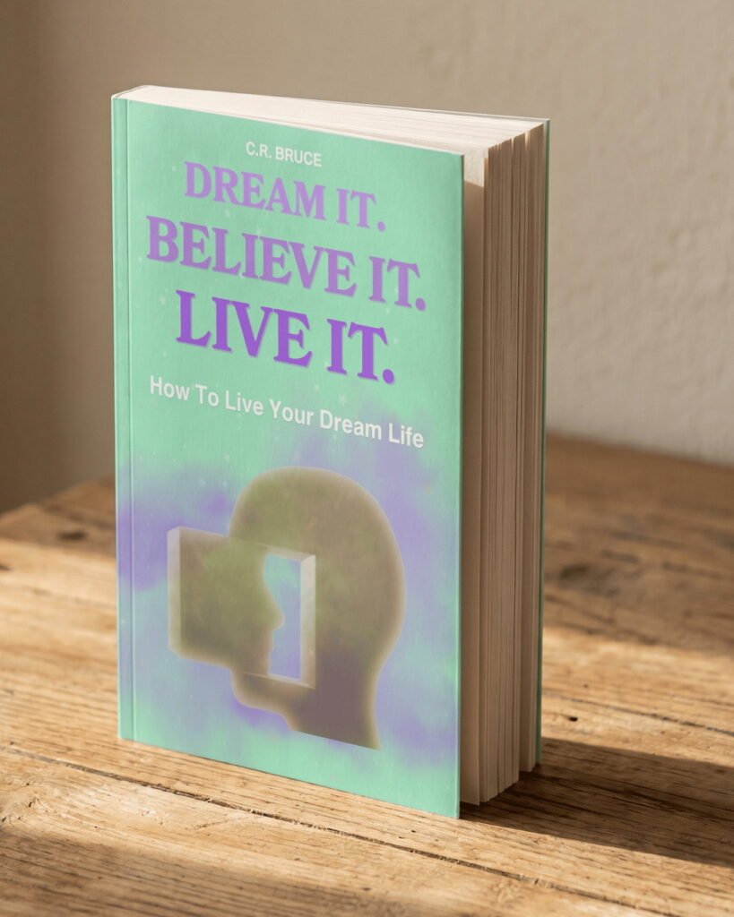 Dream It. Believe It. Live It. How To Live Your Dream Life, by C.R. Bruce, standing on a wooden table